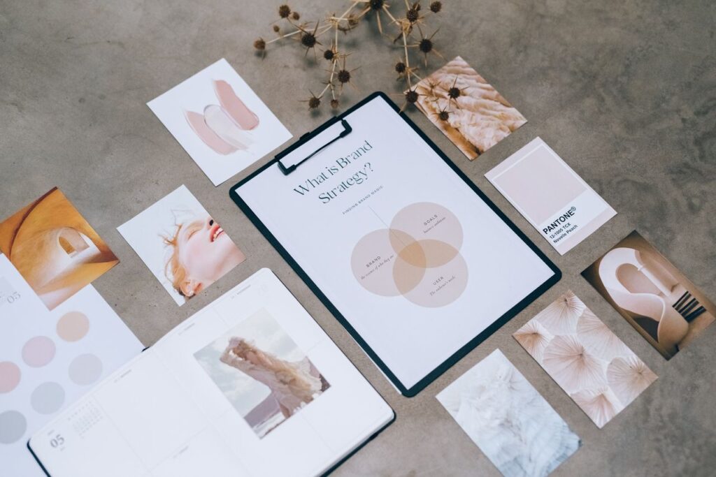 Flat lay of a minimalist brand strategy moodboard on a concrete surface.
